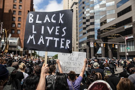 A protester holds a placard that says Black Lives Matter during the demonstration.
Protesters gathered outside the state house to protest against the murder of George Floyd under police custody.