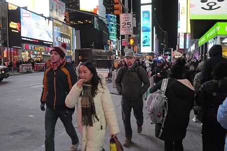 People walk in Times Square, Manhattan, New York City.