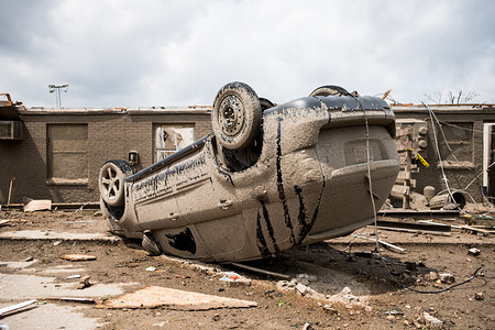 A car is seen flipped over after a tornado struck the area the night before.
At least 1 person is dead and 12 injured from the storms that hit western Ohio.