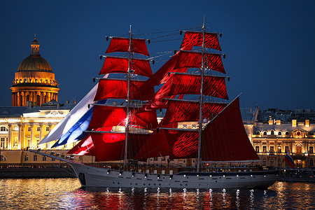 The sailing ship "Russia" with scarlet sails seen in the waters of the Neva River against the backdrop of St. Isaac's Cathedral during a rehearsal. "Scarlet Sails" is an annual graduation celebration held at the end of June. The event marks the end of the school stage of life for young people and symbolizes the beginning of a new life path. The central event of the celebration is a grand show on the Neva with illuminated buildings, musical performances and fireworks the culmination of which is the appearance of a sailboat with scarlet sails. "Scarlet Sails" has acquired the status of one of the largest and most significant cultural events in the city attracting the attention of both residents and guests.
