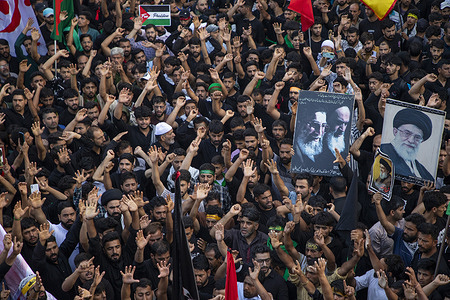 Kashmiri Shiite Muslims hold portraits of Iran's Supreme Leader, Ayatollah Ali Kahmenei as they take part in the eighth day of the Muharram procession in the city center. Amid tight security, Indian authorities allowed the 8th Muharram procession to pass through its traditional route for the third consecutive year after over three decades. This procession was banned in 1989 during a rebellion against New Delhi's rule. Shiite Muslims commemorate Muharram, the first month of the Islamic calendar as a month of mourning for the death of Prophet Muhammad's grandson, Imam Hussain who was killed in the battle of Karbala in 680 A.D.