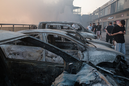 Cars burned in a forest fire are pictured. Forest fires broke out in many parts of Izmir, covering the city with smoke. The fires, which have been growing with the effect of the wind for days, also spread to Gaziemir, one of the central districts of the city. Many vehicles were burned in the fire that spread to the industrial zone. People say the response to the fire is inadequate.