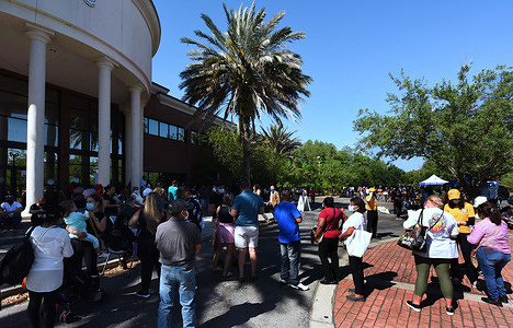 People wait in line to receive a shot of the Johnson & Johnson vaccine at a pop-up COVID-19 vaccination site in the parking lot at the Mexican Consulate in Orlando.
Doses of the one-shot Johnson & Johnson vaccine are in high demand despite adverse reactions and blood clots among a small number of patients.