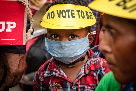 A kid is seen wearing an anti-BJP cap during the 'NO VOTE TO BJP' rally.A 'NO VOTE TO BJP' rally was staged in Kolkata with the support of local people, minority groups, students and youth of the society. Many renowned farmers' protest leaders from Delhi-Ghazipur-Noida border joined in support of the rally.