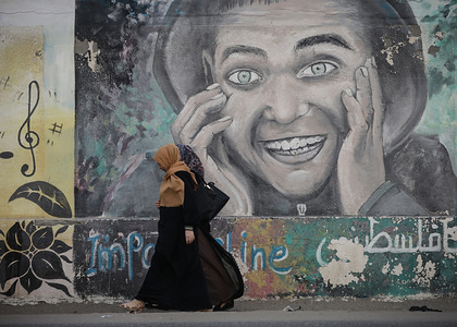Palestinian women walk past a mural painted on the wall of a UN school in the Deir al-Balah refugee camp in central Gaza Strip.
The Gaza Strip is part of the Palestinian Territories located in the Middle East. It has a population of 1.8 million in 2017.