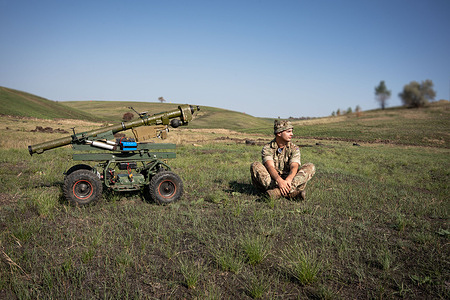 A soldier from the 25th Brigade’s drone unit poses next to Alisha, the ground drone his brigade created to take down helicopters and aircraft at the front line, after a training session in Donetsk. Members of the 25th Brigade’s drone unit train how to set up their ground drone, Alisha.