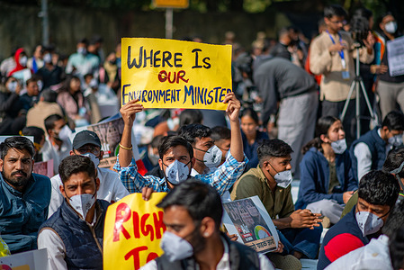 A young protester wearing a pollution protection mask holds a placard during a demonstration against air pollution and demanding urgent government action as pollution levels reach hazardous limits. The protest was held at the Jantar Mantar protest site in New Delhi, India. It was organized by the Delhi-based citizen movement “My Right To Breathe (MRTB),” which works to combat air pollution and improve public health.