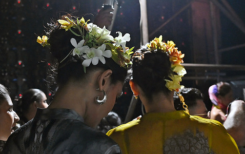 Models wearing flowers on their hair wait in a queue before the start of a fashion show on the last day of Lakme Fashion Week (LFW) in Mumbai.