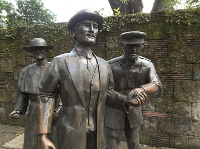 Bronze statues of Spanish Friar, Spanish soldier and a bound up Dr. Jose Rizal at the execution site of Dr. Jose Rizal.