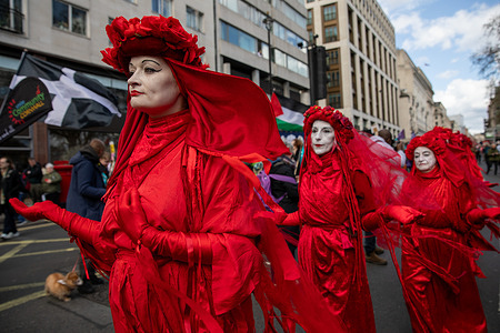 The Extinction Rebellion Red Rebels take part in an anti racism rally in Central London. Thousands joined a march and rally in London to protest against the rise of far-right politics and the divisions it is believed to create in society. The event was organised by the Together Alliance, a coalition made up of trade unions, environmental groups, community activists, faith leaders, musicians, entertainers, and elected representatives. The march began at midday on Park Lane, continued along Piccadilly past Trafalgar Square, and concluded on Whitehall.