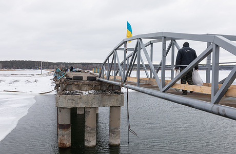 Temporarily restored pedestrian crossing over destroyed bridge across Siverskyi Donets River in Staryi Saltiv, Kharkiv region. Consequences of the war of aggression of the Russian Federation in the Kharkiv region of Ukraine. Destroyed houses, bridges, power lines. After de-occupation, life is being rebuilt and Ukrainians are actively rebuilding what can be rebuilt.