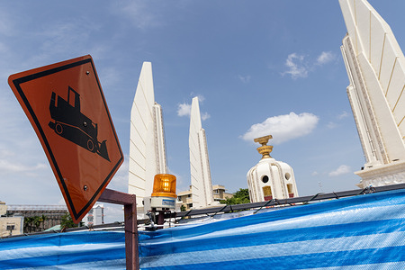 A construction sign is seen in front of Democracy Monument during subway construction on historic Ratchadamnoen Avenue. The MRT Orange Line is under-construction in Bangkok, the eastern route passes beneath Ratchadamnoen Avenue, close to the Democracy Monument, Sanam Luang, and Lan Luang, all significant cultural landmarks