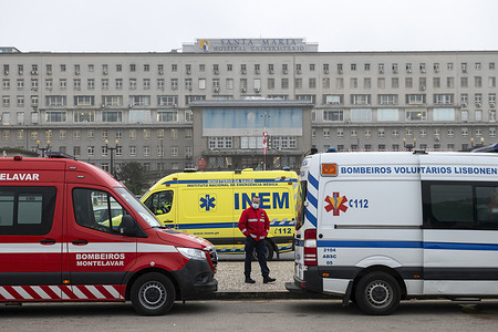 Ambulances waiting in a queue amid Covid-19 pandemic.
Dozens of ambulances line up to drop off patients infected with Covid-19 at the Santa Maria hospital in Lisbon. The wait can take up to 12 hours. While waiting, patients receive assistance inside the emergency vehicles.