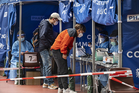 Residents are seen at a Covid-19 coronavirus testing facility after a large number of positive cases have risen during the last days in Hong Kong.