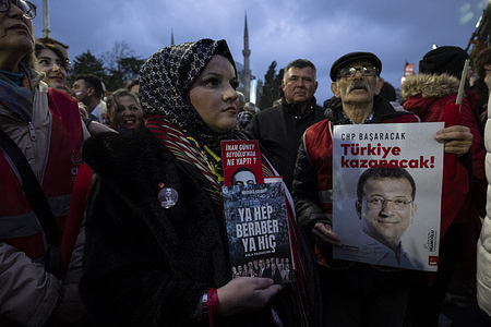 Supporters hold posters and shout slogans during a rally protesting to mark one year since the arrest of the city's Mayor Ekrem Imamoglu 's detention at Sarachane Square. Thousands of protesters in Saraçhane to mark the first anniversary of the detention of Ekrem İmamoğlu, the former Mayor and the Republican People's Party (CHP) Presidential candidate, who was arrested and removed from office.