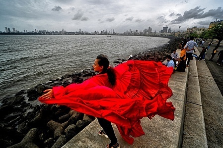 A model (Rohini) poses for a documentary fashion shoot at the famous Marine Drive of Mumbai. The Project documents the popular travel destination initiative designed for local tourists during the post-monsoon season organised by Creative Art Solution , A registered Photography Club of India. Marine Drive is a 3.6-kilometer Art Deco-style promenade in Mumbai, built on a natural bay, that connects Nariman Point to Chowpatty Beach