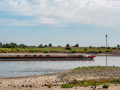 A cargo ship is sailing slowly through the Waal River. After four heatwaves and a very dry month, locks are being used less frequently, shipping routes are being restricted, and the consequences of the drought are being felt throughout the country. The Netherlands is currently on “alarm phase two,” which means there is an actual water shortage. The next phase, phase three, is a water crisis. It is unclear when phase three will be declared.