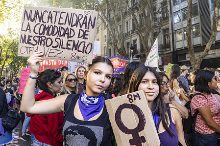 Two young women hold placards against gender violence during the demonstration. Thousands of women marched in Buenos Aires to commemorate International Women's Day. The demonstration took place the day after March 8th with the aim of highlighting the impact and contribution of women to society. It also served as a platform to protest Milei's social and economic policies.