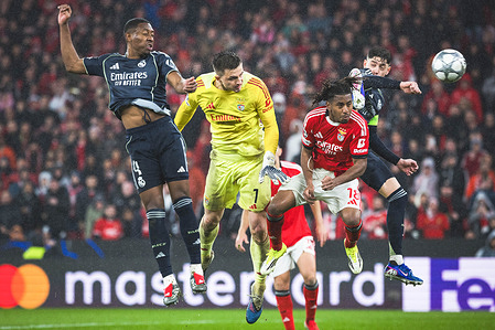 Anatoliy Trubin of SL Benfica heads (LC) towards the goal, between players David Alaba of Real Madrid CF (L), Leandro Barreiro of SL Benfica (CR) and Federico Valverde of Real Madrid CF (R) during the UEFA Champions League 2025/26 League Phase MD8 match between SL Benfica and Real Madrid CF at Estadio da Luz. Final score; SL Benfica 4 : 2 Real Madrid CF.