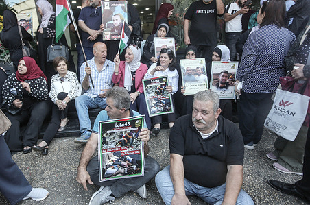 Families of Palestinian prisoners hold portraits of their detained relatives during a solidarity rally in the city of Nablus, in the northern occupied West Bank. Palestinians staged a protest to demand a prisoner exchange agreement with the Israeli government and Hamas.