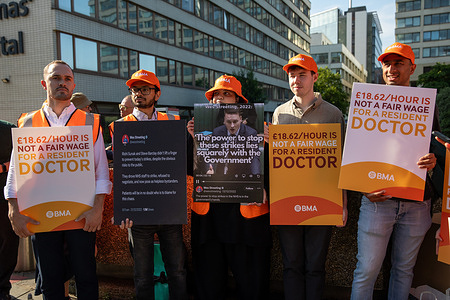 A group of striking resident doctors holds placards on a picket line. Resident doctors previously called junior doctors took part in a 5-day strike over pay and conditions. Up to 50,000 doctors and their supporters joined picket lines outside major hospitals across the UK. The most significant picket line was located outside St Thomas’s Hospital where several hundred resident doctors participated in a demonstration at the main entrance throughout the day holding placards.