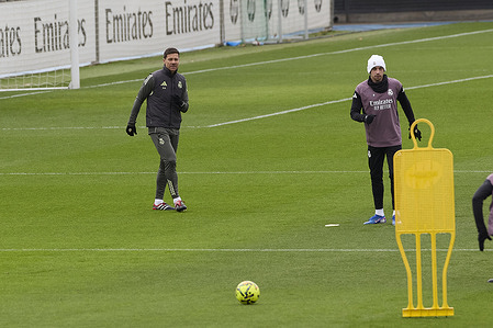Xabi Alonso (L), the head coach of Real Madrid CF and Federico Valverde (R) of Real Madrid CF look on during a training session at Ciudad Real Madrid, on the eve of the La Liga EA Sports 2025/2026 week 18 football match between Real Madrid CF and Real Betis Balompie.