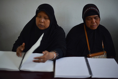 Blind muslims women seen reading the braille Quran during Ramadan.
Muslims across the world are observing the holy month of Ramadan,
which refrain them from drinking, eating and smoking from dawn until dusk.
