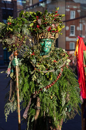 The Holly Man from the Lions Play during the Twelfth Night celebrations. The Lions Part theatre company hosts an annual urban festival marking the end of Christmas with apple tree wassailing, a tradition in English culture. The event starts outside Shakespeare’s Globe, featuring wassailing for a good harvest, a traditional mummers play at Bankside Pier, and a parade along the Thames Path to Borough Yards. Activities include dancing, storytelling, singing, and the Kissing Wishing Tree. The group specializes in seasonal events that blend theatre, music, and heritage.