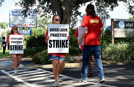 Union members hold placards in front of an AT&T office as a strike by the Communication Workers of America enters its fifth day across nine Southern states.
More than 20,000 CWA union members walked out after charging that the telecommunications company isn't bargaining in good faith over a new contract.
