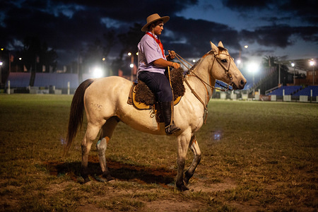 A Gaucho (Cowboy) seen riding a horse during the "Criolla Week" rodeo in Montevideo.

Every April since 1925, the Criolla Week Festival is celebrated in Montevideo where Gaucho (Cowboy) ride wild horses to perpetuate the country's tradition. Apart from the Rodeo show there are several musical shows and traditional gastronomy.
