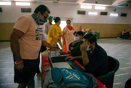 People seen at the registration desk for the covaxin Covid-19 vaccine at Government vaccination centre, Ramleela Ground.
In the last 24 hours 3,381,671 people were vaccinated against Covid-19 all over India, according to the Health Ministry Data.