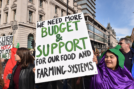 A protester holds a placard during the demonstration. Farmers and farmworkers from across the UK protested in London to demand more government ambition on future food and farming policy.