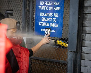 Police pepper spray a photographer after warning him to back up near the gates of the Metropolitan Detention Center during an ICE Out for Good demonstration in Los Angeles.