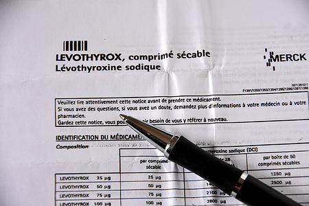 A ballpoint pen is seen resting on the unfolded leaflet of the drug Levothyrox. The pharmaceutical company Merck, which markets Levothyrox, has been indicted for aggravated deception in connection with the change in the formula of the drug. Several thousand patients treated with this new formula of the drug indicated in the treatment of thyroid disorders have complained of heavy side effects and have filed a complaint against the German laboratory.