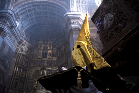 Penitent from "La Soledad" brotherhood in the "Jeronimos" Monastery before taking part in the Good Friday procession.
Every year thousands of christians believers celebrates the Holy Week of Easter with the crucifixion and resurrection of Jesus Christ.