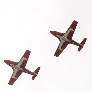 Two Canadian Snowbirds fly over downtown as they head out on their final tour in their current plane, the Canadair CT-114 Tutor which they have flown since 1971. The Canadian Forces Snowbirds Canadair CT-114 Tutor is being retired this year. The team will not perform until the new the CT-157 Siskin II is brought online in 2030,
