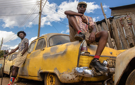 21-year-old Jacktone Omondi (R) an Electrician and model and 24-year-old Dennis Juma (L) a Visual Artist and street model pose by a Vintage car dressed in Vintage outfits in Nairobi.Modern fashion is now becoming a new trend practiced by different individuals in the African society, new technology has introduced an advanced and more designed uniformity of look-alike outfits that become more expensive with each day. While modern fashion continues to rise in demand, a group of young models in Nairobi is making a comeback with the early 70's vintage dress code. The young models are now reincarnating the old fashion and making it apart of the modern trend to remind the modern generation about the generation that is gone.