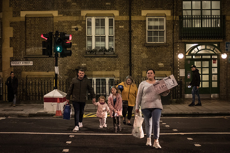 A family crosses the street.