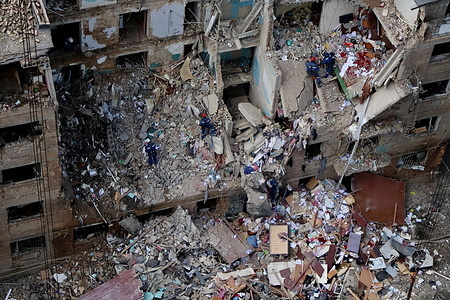 Ukrainian rescuers conduct a search operation in a residential building heavily damaged amid the Russian invasion. Russia has launched its latest missile and drone strike killing at least nine people as Moscow steps up airstrikes on civilian infrastructure.