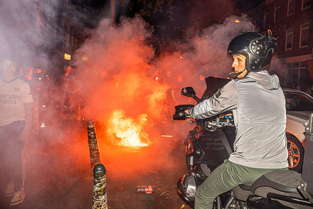 Dutch supporters celebrate their 2-1 win against Turkey, on the Marktweg with flares and fireworks, during the European Football Championship 2024. The Netherlands team beat Turkey 2-1. The match against Turkey took place in Berlin, Germany. In The Netherlands Dutch football fans decorate their homes in the National patriotic colour of orange, in the run-up to the European Football Championship 2024. This Tradition arose in the early 1990's, when streets and squares in The Netherlands were draped in the National flag and the colour orange, during the European Championship and World Cup.