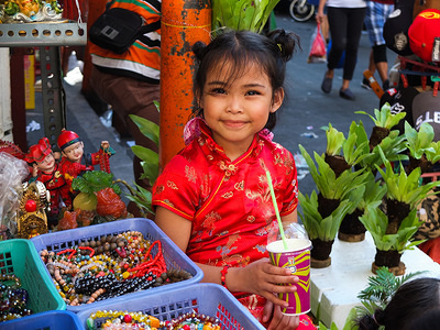 A young girl wearing cheongsam, a traditional chinese dress for women, smiles while quenching her thirst.
Filipinos celebrated the Chinese New year by visiting chinatown in Binondo to enjoy special performances, such as the Dragon dances fireworks, Chinese foods and goods.