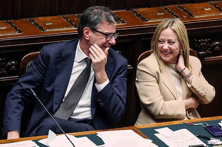 Prime Minister of Italy Giorgia Meloni, jokes and laughs with the Minister of Economy and Finance Giancarlo Giorgetti during the meeting. Italian Prime Minister Giorgia Meloni addresses the Chamber of Deputies ahead of the European Council.