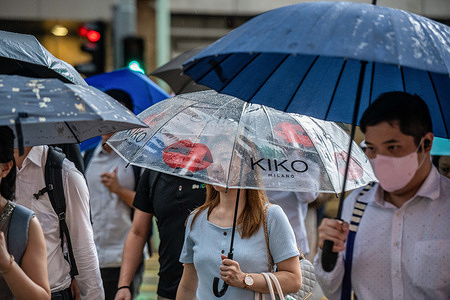 Commuters take shelter beneath their umbrellas as they make their way to work in the pouring rain. Hongkongers woke up to another Red Rain Warning Signal, as more than 50mm of rain was expected to fall during the morning hours. Schools were shuttered and commuters dodged puddles amidst the downpour. With more than 1000mm of rain recorded in the past two weeks and nine rain warnings issued to date, this September may be the wettest on record.