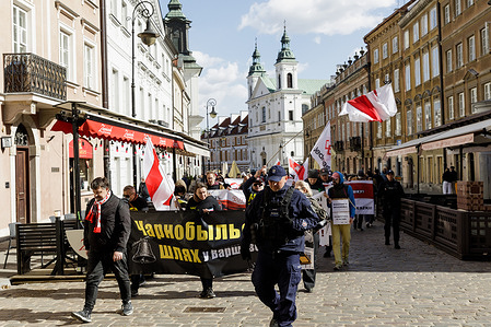 Belarusian activists and community leaders seen marching through the streets during the “Chernobyl Way” rally marking the 40th anniversary of the Chernobyl nuclear disaster. Representatives of the Belarusian diaspora, including activists and community leaders, gathered in central Warsaw for the traditional “Chernobyl Way” memorial rally marking the 40th anniversary of the Chernobyl nuclear disaster. Representatives of the “Euromaidan Warsaw” initiative and the diaspora of the Chechen Republic of Ichkeria also took part in the event. Around one hundred participants gathered near the Nicolaus Copernicus monument and marched to the Maria Skłodowska-Curie monument.