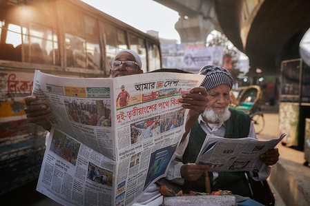People read newspapers displaying headlines on preliminary results of the 13th National Parliament Election and referendum at street stalls and on city walls in Dhaka. While the Election Commission had yet to officially announce the final results, preliminary counts indicated that the Bangladesh Nationalist Party (BNP) was leading. Newspapers highlighted updates on the potential formation of a new government following nationwide voting and counting.
