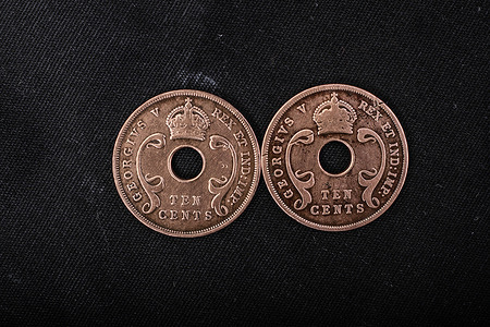 In this photo illustration, the historic 1928 and 1933 Colonial British East Africa 10-cent coins with inscriptions ‘’GEORGEIVS V REX ET IND: IMP’’ and a crown are displayed. Queen Elizabeth took the reigns of power from his father, King George VI, who died in February 1952. She learned about her father's death while on a visit to Kenya. Queen Elizabeth II died yesterday, September 8, 2022, at Balmoral Castle in Scotland, UK.