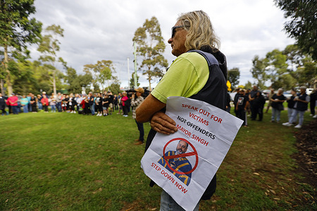 A protester holds a placard during the rally.  A protest took place outside the Wyndham Civic Centre as pressure grows on Wyndham Mayor Preet Singh following controversy over a character reference he provided for a convicted child sex offender. According to ABC News, Singh stepped aside temporarily and apologized, while community members and councilors continue to call for his resignation.