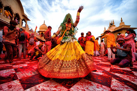 A transgender woman dances during the Laddu Holi celebrations at the Radharani temple of Barssana - Uttar Pradesh. The spring festival of colors at Radharani temple in Barsana village of India's Uttar Pradesh is the first day of the Celebration of the main Holi Festival. At this festival the devotees and priests of Barsana Temple throw Laddu (Traditional Sweet) on each other. Holi is a spring festival also known as the festival of colors or the festival of love.