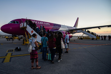 Passengers seen boarding a Wizz Aircraft Airbus 320 at Sa Carneiro airport.