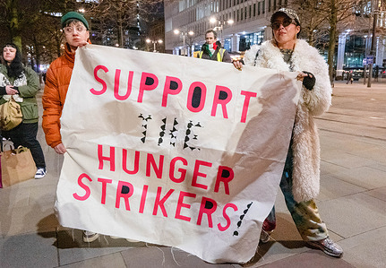 Protesters hold a banner in solidarity with the eight ongoing hunger strikers who are detained for actions of protest concerning Palestine. The demonstration took place in Manchester city centre outside the Central Library in St Peter's Square Manchester.